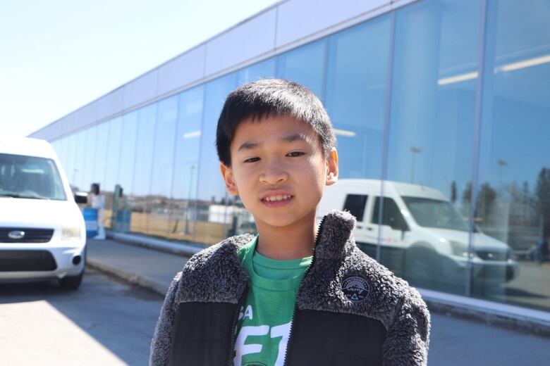 Young boy looks at camera.