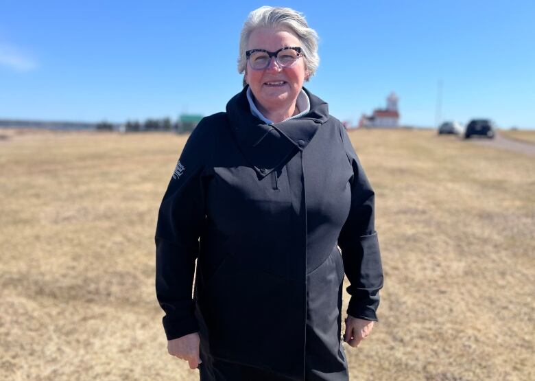 Woman standing in field.