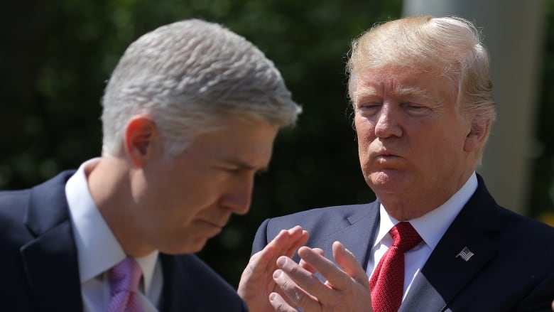 Trump claps with Judge Gorsuch in foreground