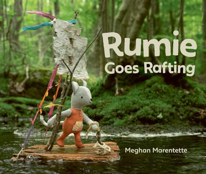 Rumie Goes Rafting by Meghan Marentette. Book cover is a photo of a crafted small creature in orange overalls on a raft in the woods. 