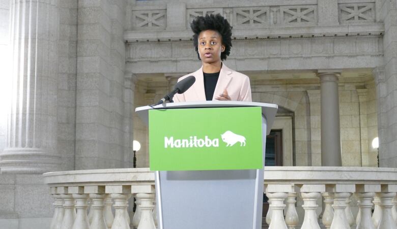 A woman speaking from behind a podium