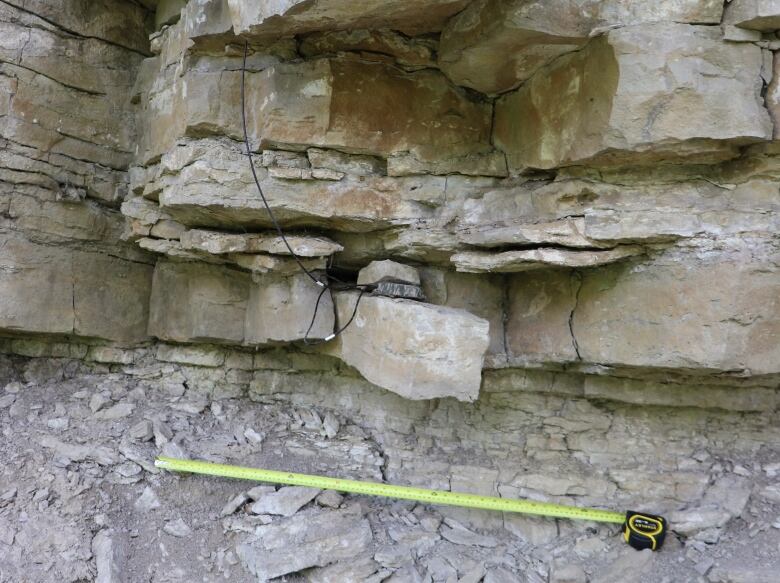 A wire coming out of a rock face