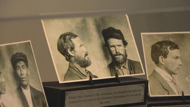 three photos in a museum glass case. 