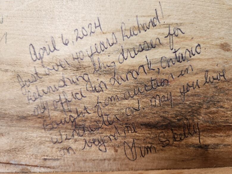 Handwritten note on a dresser drawer