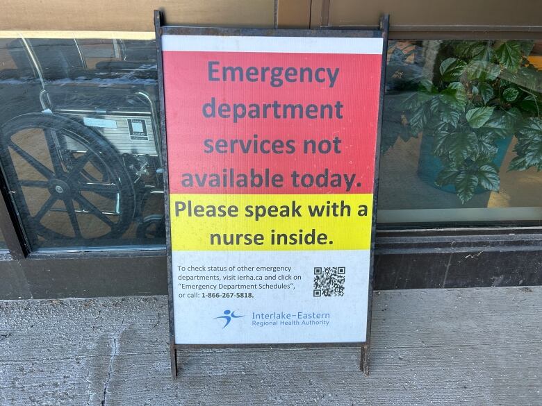 A sign placed outside the Arborg hospital reads emergency department services not available today. Please speak with a nurse inside.