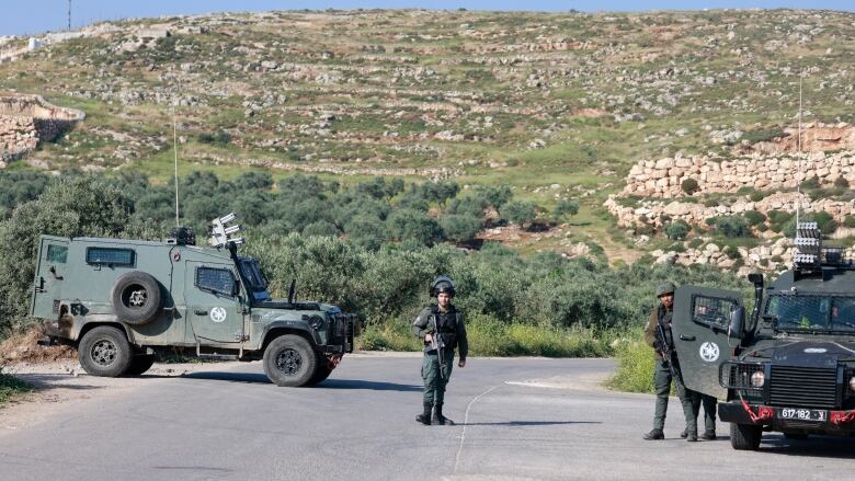 Israeli security forces are seen at a checkpoint at a West Bank village near Ramallah on Saturday.