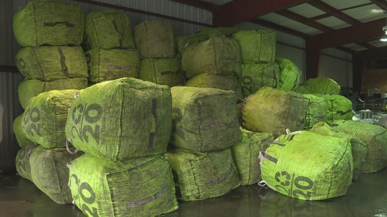 A stack of green bags in a warehouse