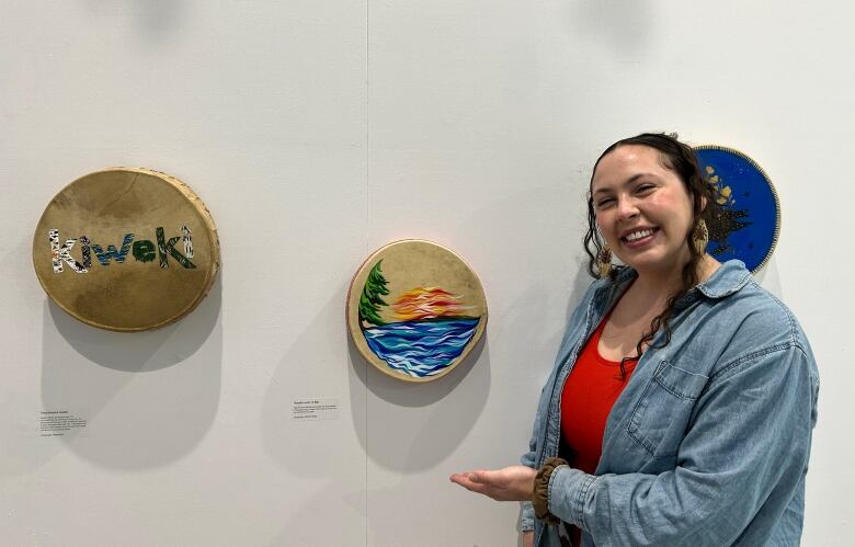 Woman standing next to drum