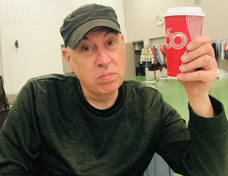 A man holding a coffee cup.