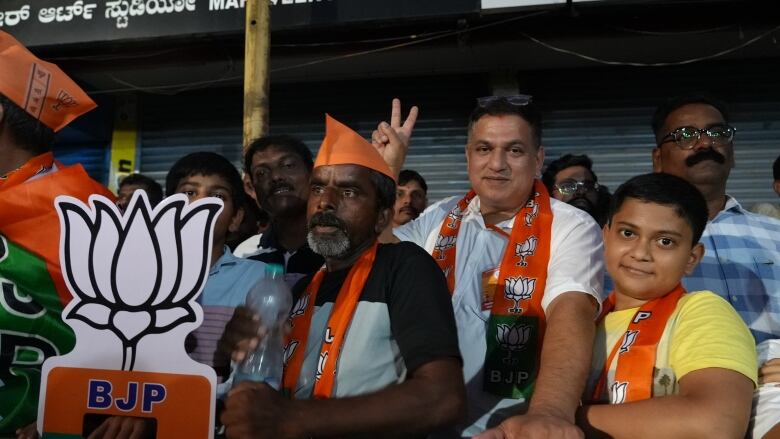 People stand at a political rally.