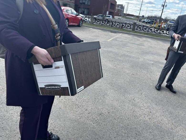 A woman holding a brown box