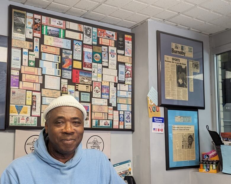 Ticket broker Kingsley Bailey stands in front of his collection of tickets