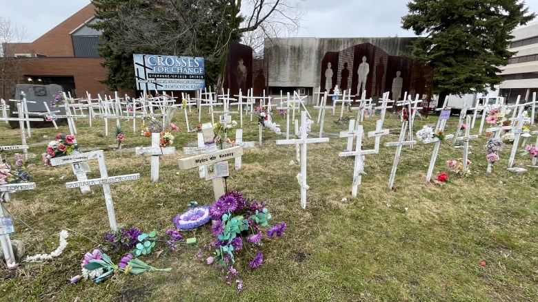 An open area with rows of white crosses.