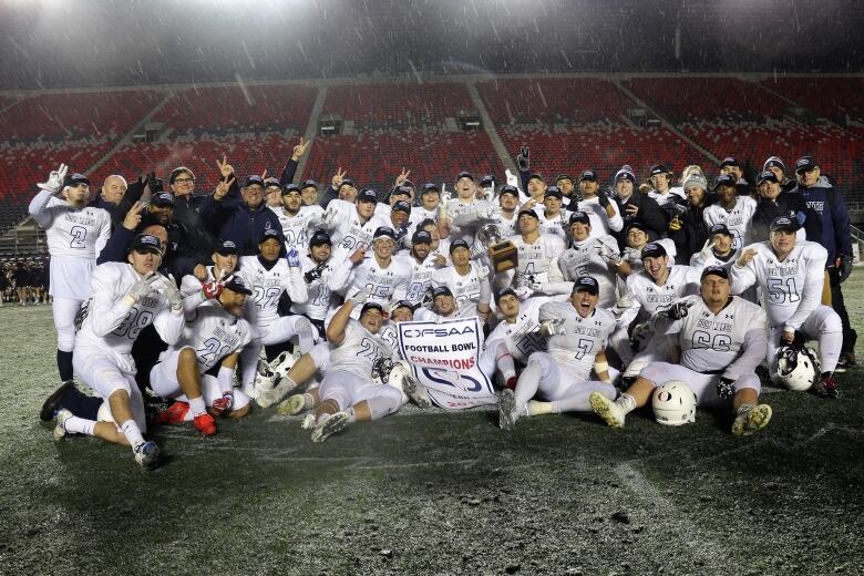 A team of football players in white jerseys