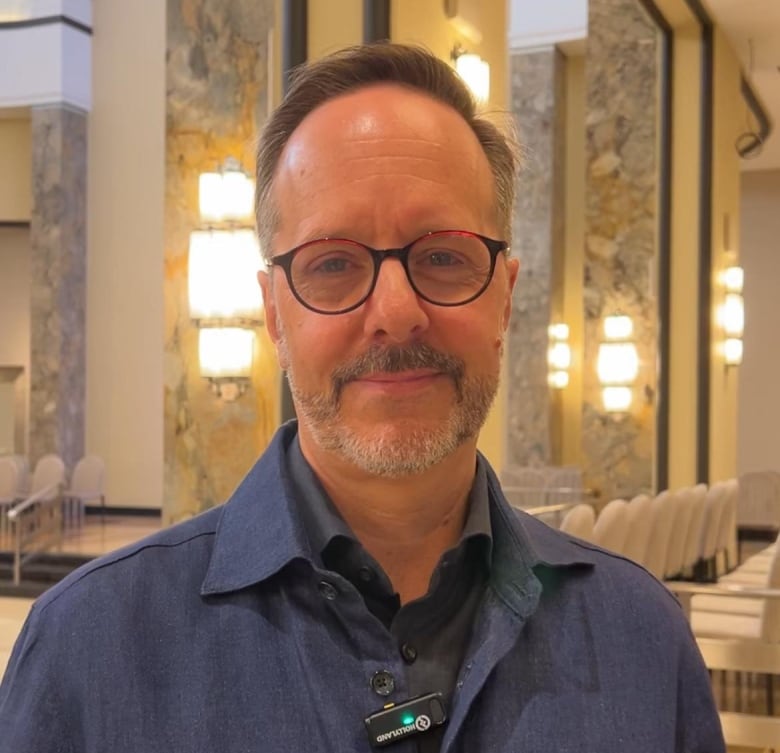 A white man with a salt and pepper beard and glasses