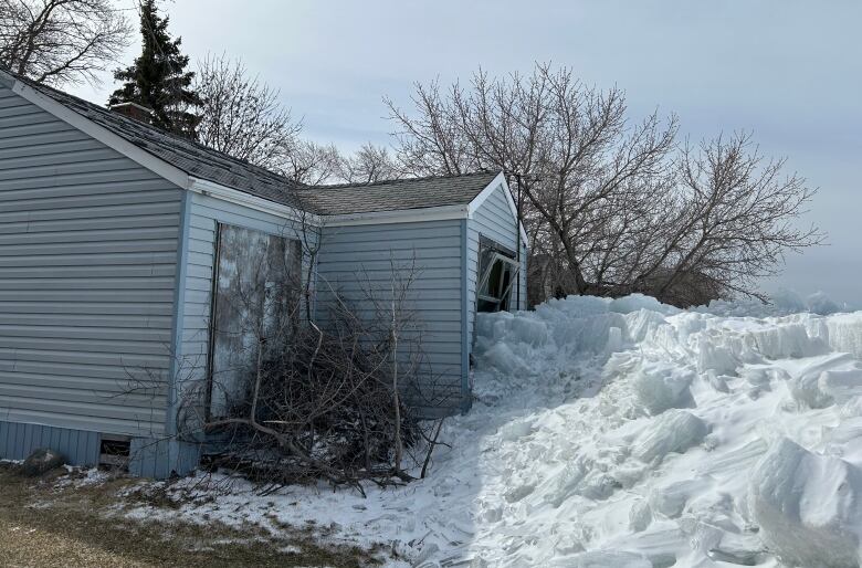 The facade of a building covered with snow and ice.