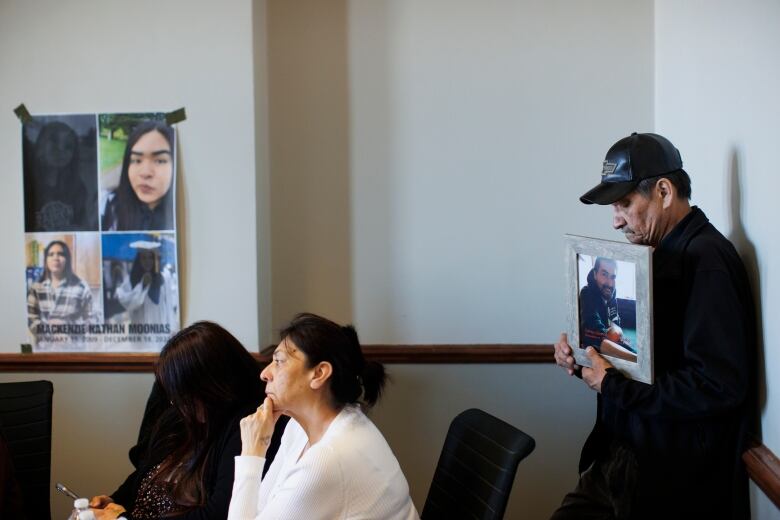 A man holds a picture.