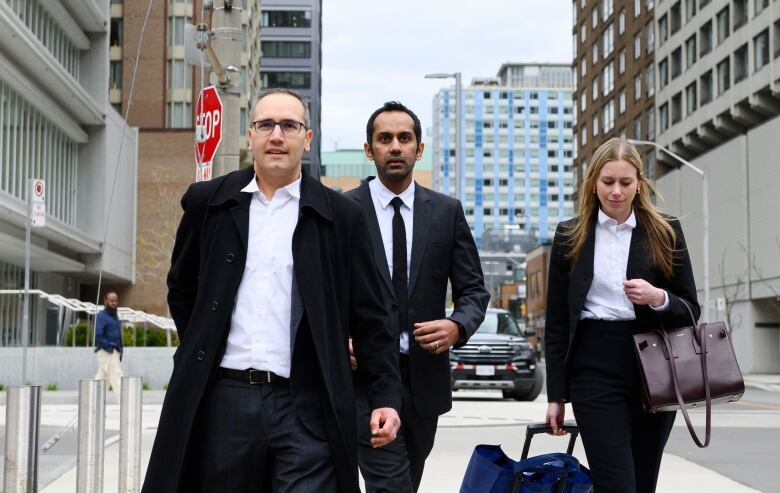 Umar Zameer and his lawyers walk away from the courthouse following his not guilty verdict, in Toronto, Sunday, April 21, 2024. THE CANADIAN PRESS/Christopher Katsarov