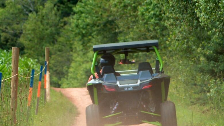 All-terrain vehicle driving along path.