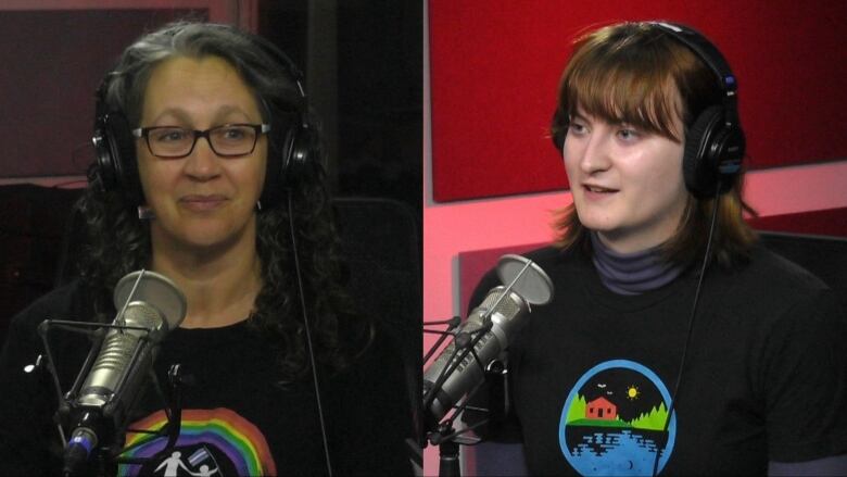 Two women wearing black t shirts sitting inside of a radio studio. 