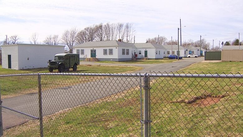 Army truck behind a fence.