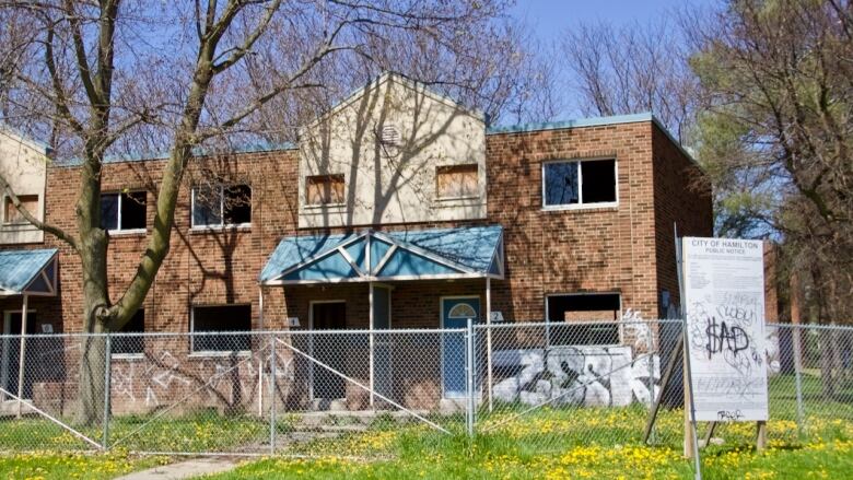 townhouse with boarded up windows 