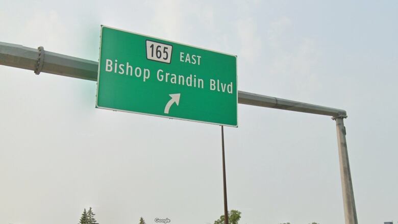 A green roadway sign says Bishop Grandin Blvd