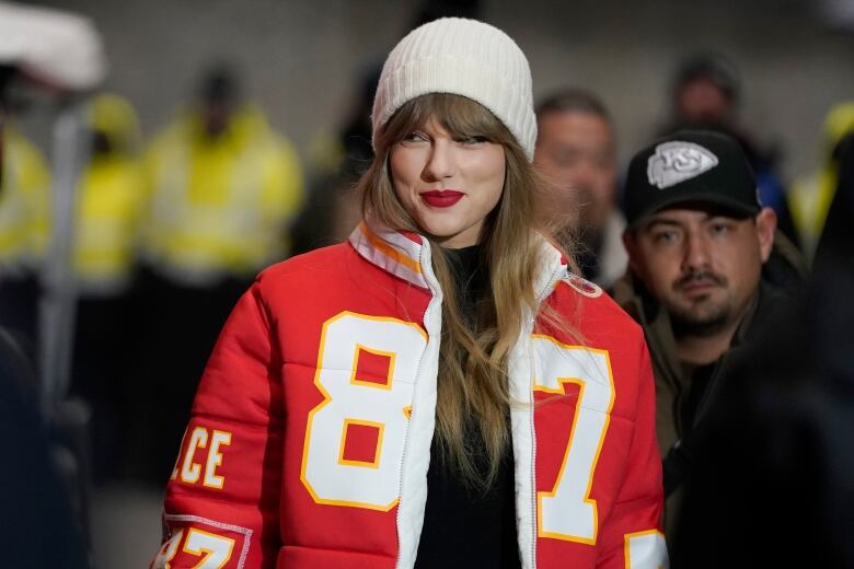 Taylor Swift wearing a Travis Kelce jacket. 