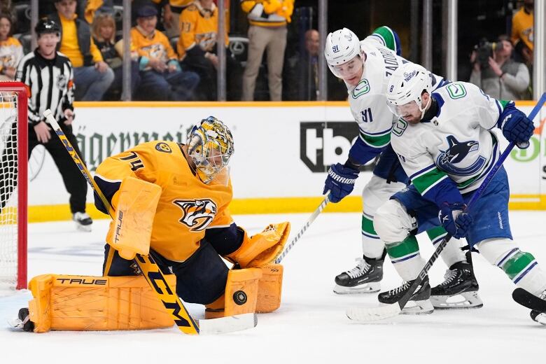 A goalie blocks a shot.