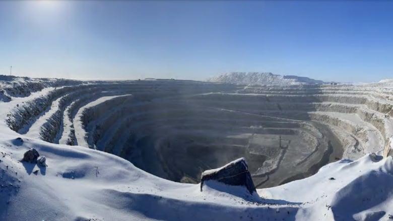 An open pit mine in snow.