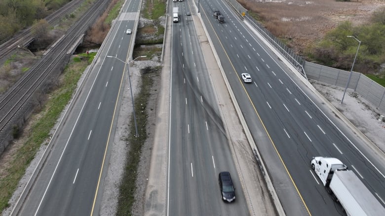 A highway with skid marks is seen from the air