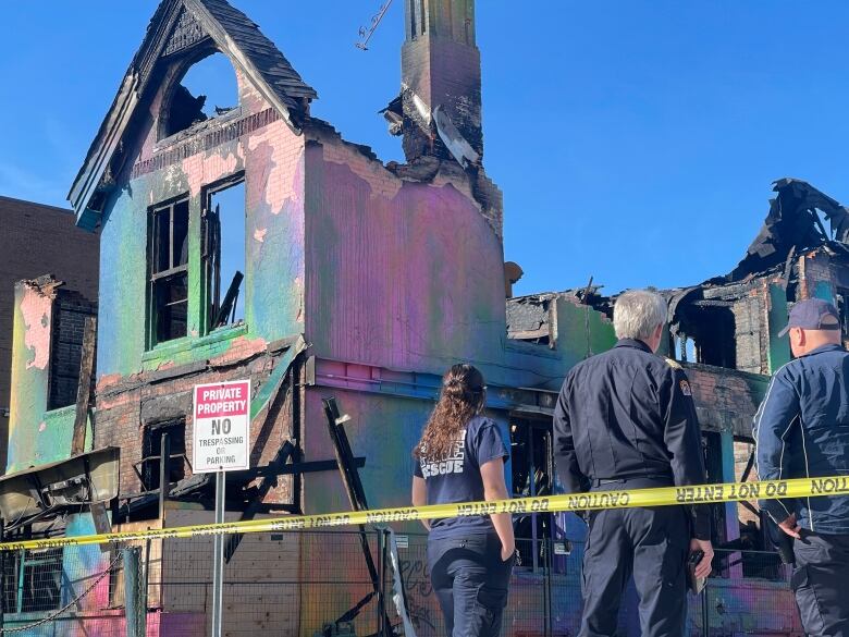 Emergency crews look on at Windsor's 'rainbow' house after it was destroyed by fire.