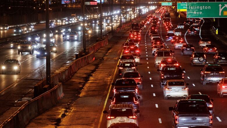 Busy lanes of highway traffic. 