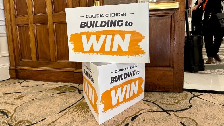 Two stacking signs for Nova Scotia NDP Leader Claudia Chender show her name and the slogan, 