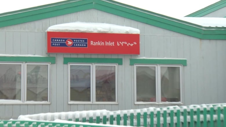 The snow-covered Canada Post office in Rankin Inlet, Nunavut is pictured with its traditional big red sign with Inuktitut syllabics.