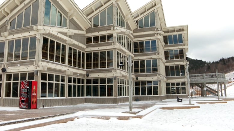 a large ski lodge with lots of windows.