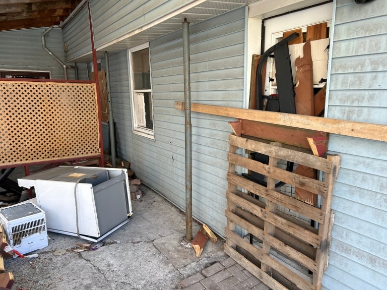 A boarded-up door on a home.