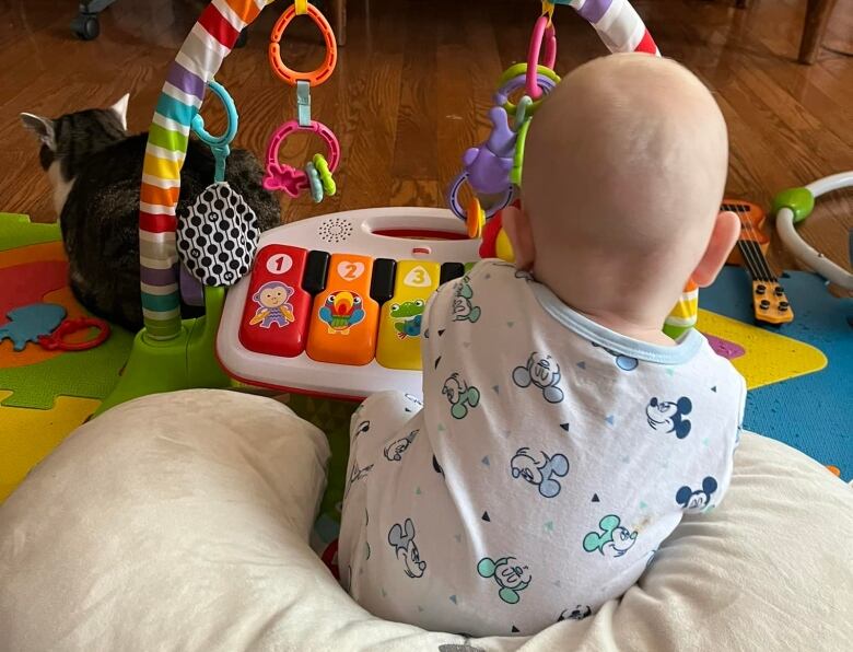 The back of a baby playing 