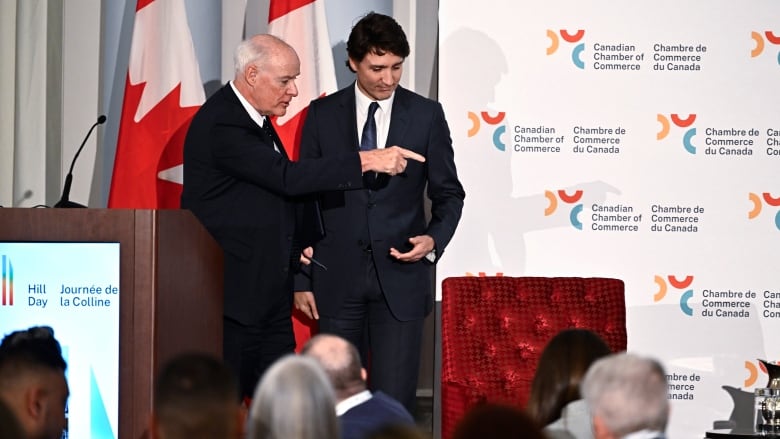 Perrin Beatty, president of the Canadian Chamber of Commerce, points Prime Minister Justin Trudeau to his seat for a fireside discussion, after Trudeau's remarks at the Canadian Chamber of Commerce Hill Day in Ottawa, on Monday, April 15, 2024. Prominent business groups are backtracking their claim that one in five Canadians will be affected by federal government's proposed changes to capital gains taxation.