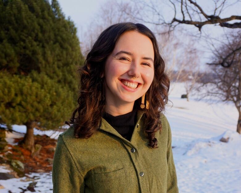 A smiling caucasian woman with shoulder-length brown hair. 