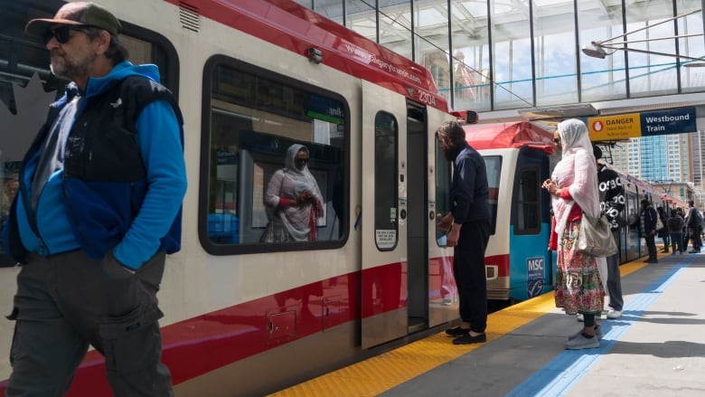 People get on and off the C-Train at a station in downtown Calgary in this file photo from May 2024. 