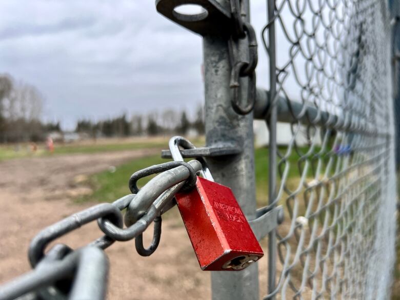 A red locked on a closed fence