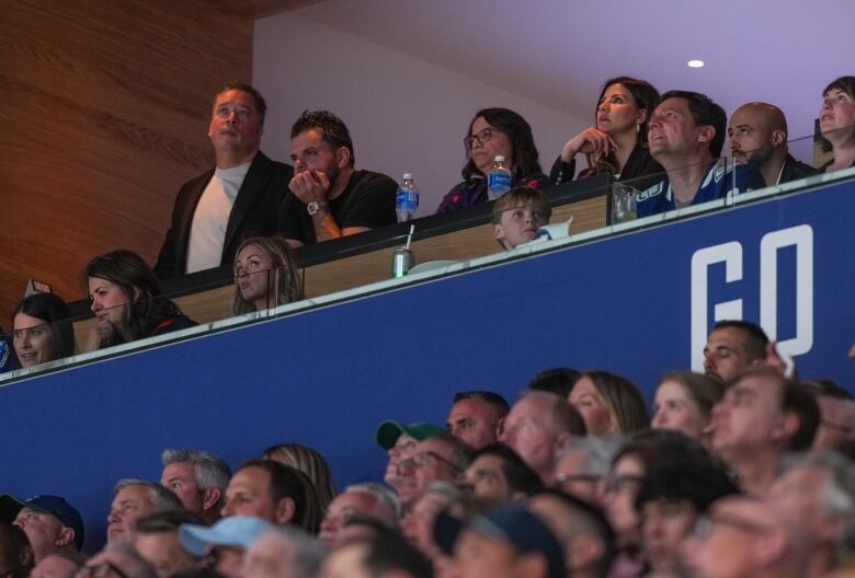 People sit in a private box to watch a hockey game.