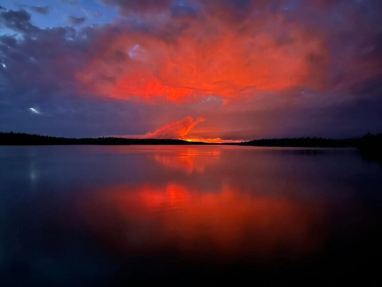 A fire burns across a lake.