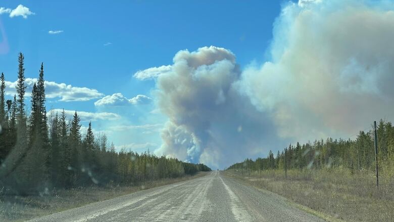 Smoke billowing along a dusty road.