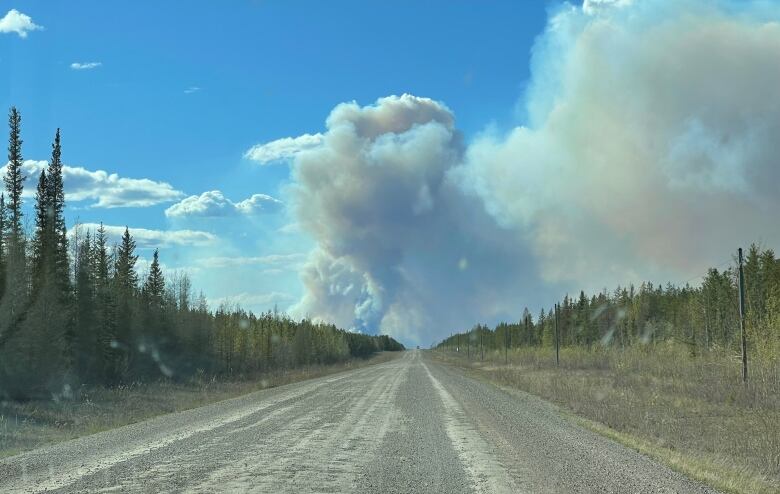 Smoke billowing along a dusty road.