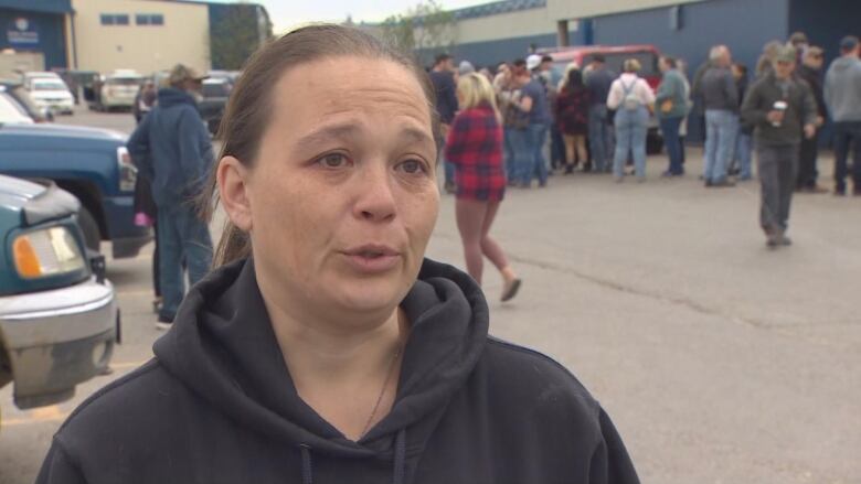 A woman in a parking lot.