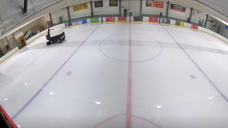 A zamboni crosses across an ice surface