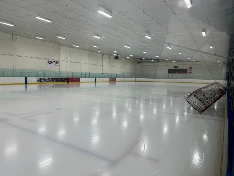 A net leans on the boards of an indoor ice hockey rink