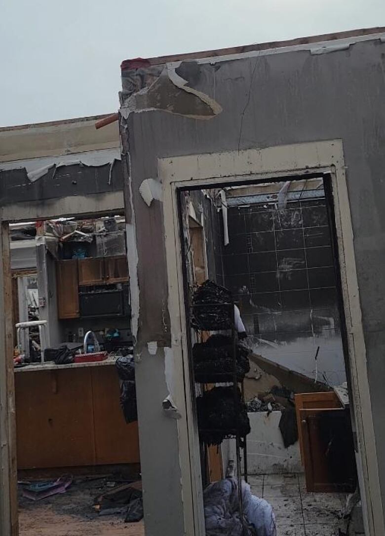 A burned-out, damaged apartment with no roof.